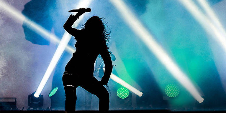 woman on stage singing rock music